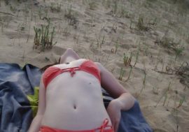 lying on her back in her red bikini