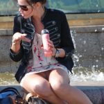 accidental upskirt of amateur sitting at a fountain eating