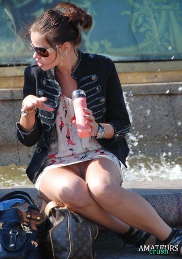 accidental upskirt of amateur sitting at a fountain eating