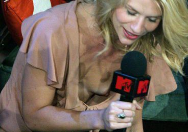 MTV reporter showing public nip slip on tv while bending forward a bit