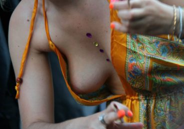 babe at a festival having a public nip slip because of a dress malfunction