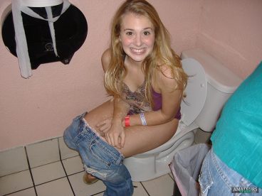 forced awkward smile by teenage girl peeing in toilet