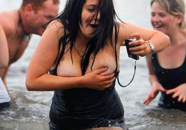 wet curvy babe having a bikini oops moment in the water and showing her tits out