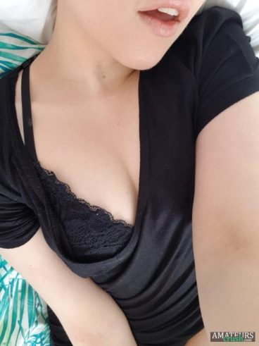 College girl selfie in her black shirt and bra showing a little bit of skin
