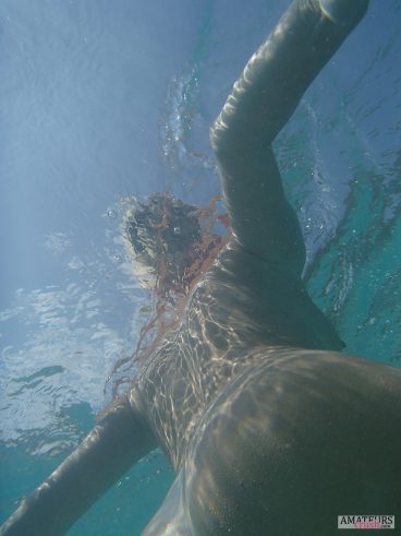 Underwater sideboob of wife swimming nude in the sea