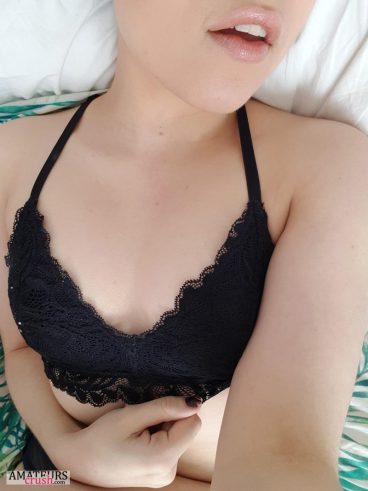 Hot collegegirl lying on her bed with only her black bra