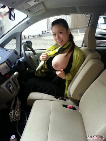 Asian MILF flashing her big boob inside her car