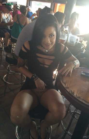Hottie doing a public pussy flash at a bar with no panties under her sexy dress