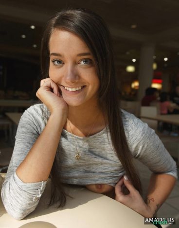 Sneaky girlfriend flashing her tits on desk in public