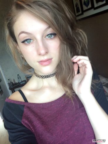Young gorgeous teen making selfie in her purple black shirt