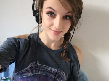 Cute 19yo gamer girl with headset on 