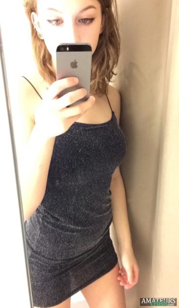 Sexy tight black dress on 19yo teen taking a selfie