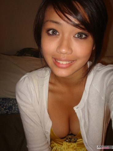 Downblouse selfie of sexy Asian girl with her hot cleavage