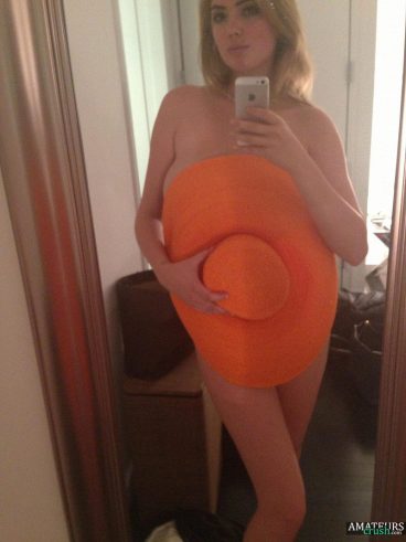 Teasing nude Kate Upton covering her parts with a big orange hat