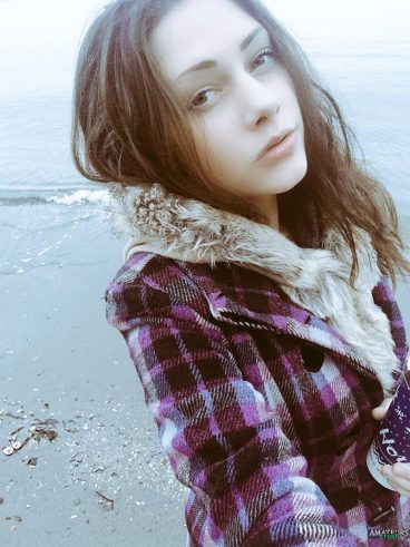 Beach selfie of cambabe Avari in her coat