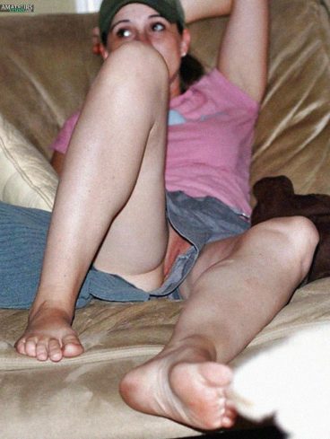Legs open of college girl on couch having pussy slips