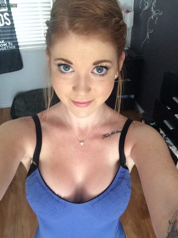 Cute selfie of natural ginger in blue top