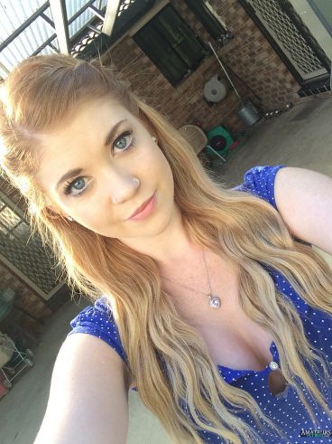 Selfie of cute hot red head girl in blue shirt outdoor