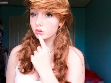 Innocent sexy redhead teen selfie thinking photo