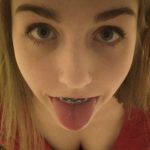 Sweet teen girl with braces sticking her tongue out teaser FI